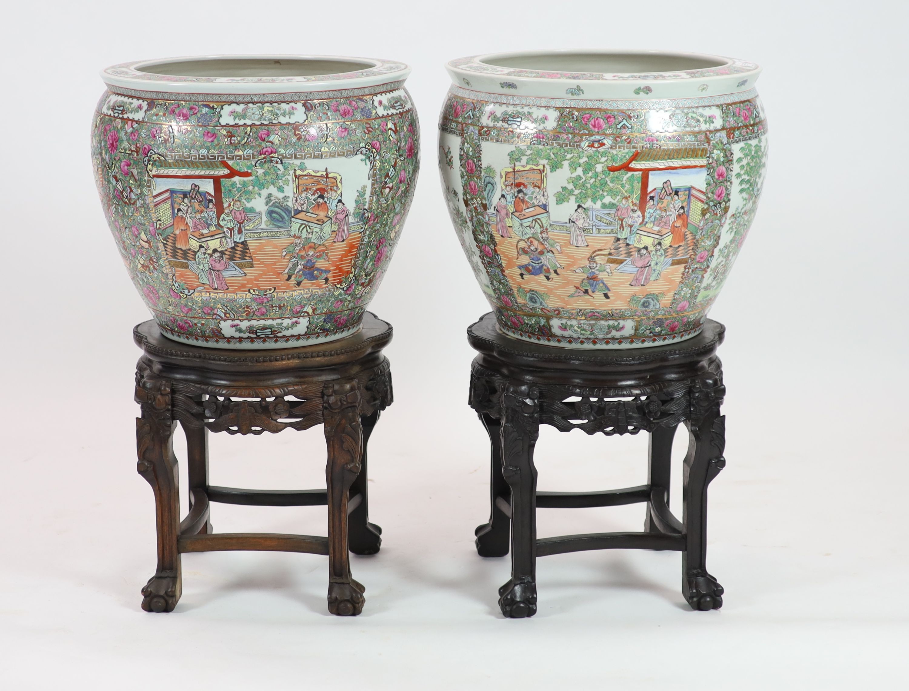 A pair of Chinese famille rose ‘goldfish’ bowls, 56cm diameter, with ebonised and marble inset stands, total height 91cm